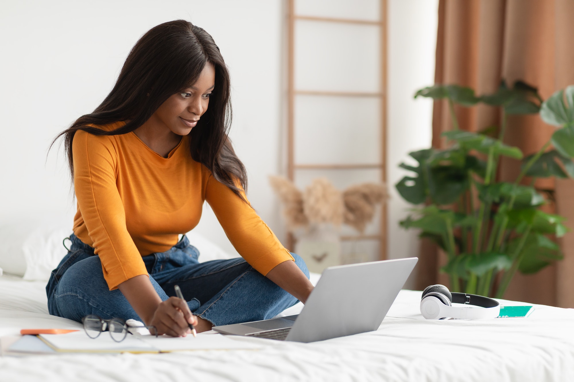 Black Woman Taking Notes Sitting At Laptop Learning At Home