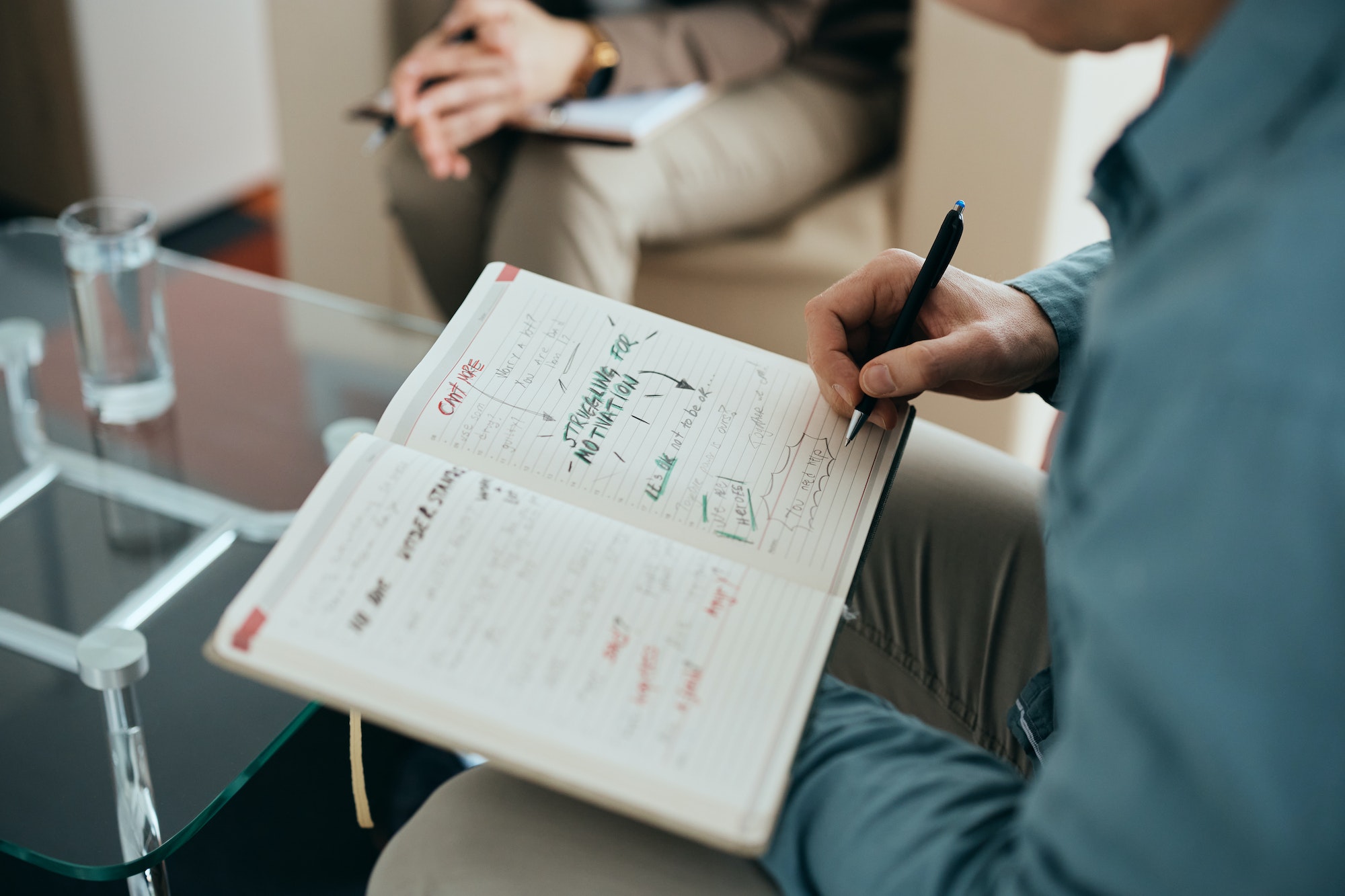 Close-up of man brainstorming during therapy with his psychiatrist.